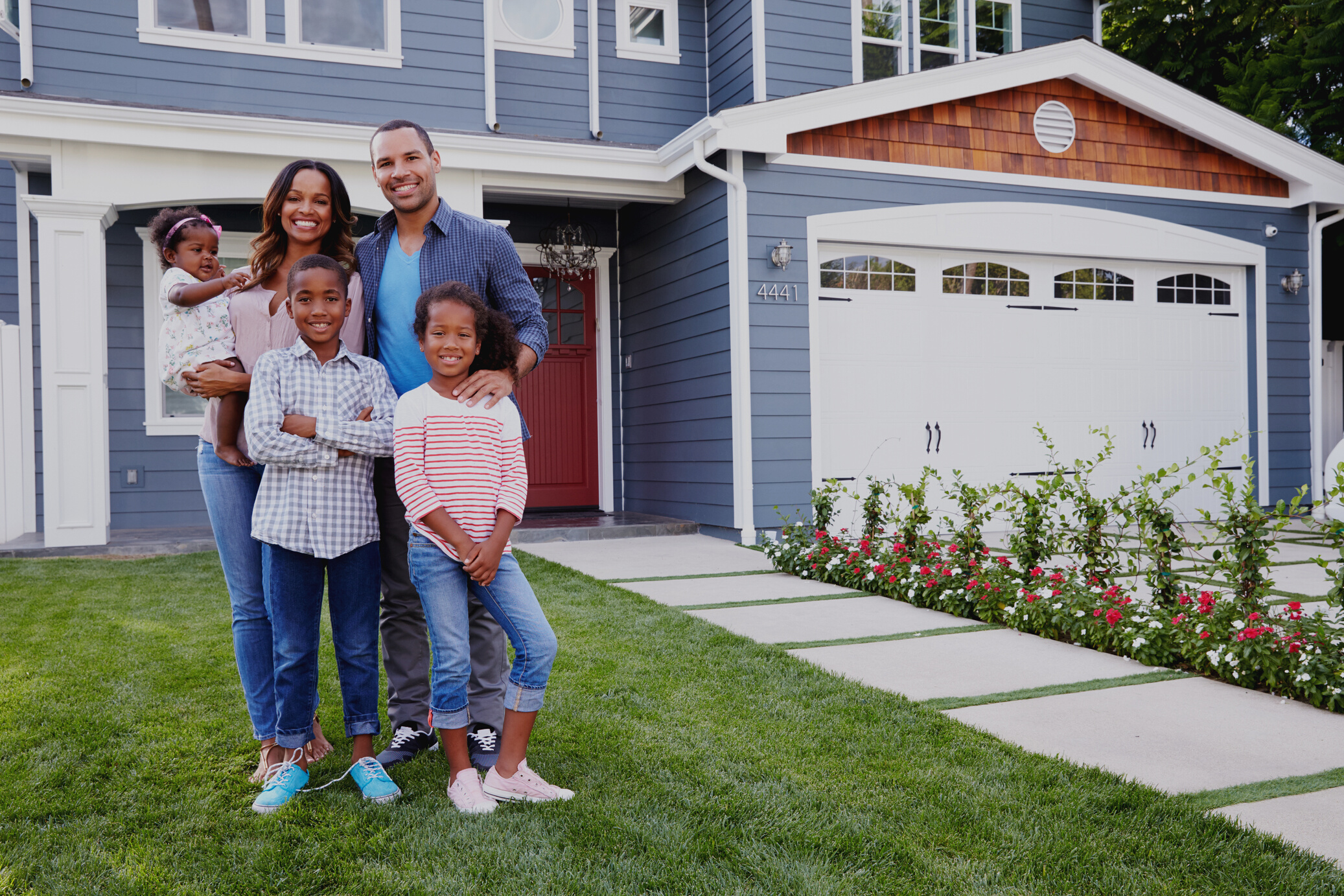 Happy Black Family Standing outside Their House